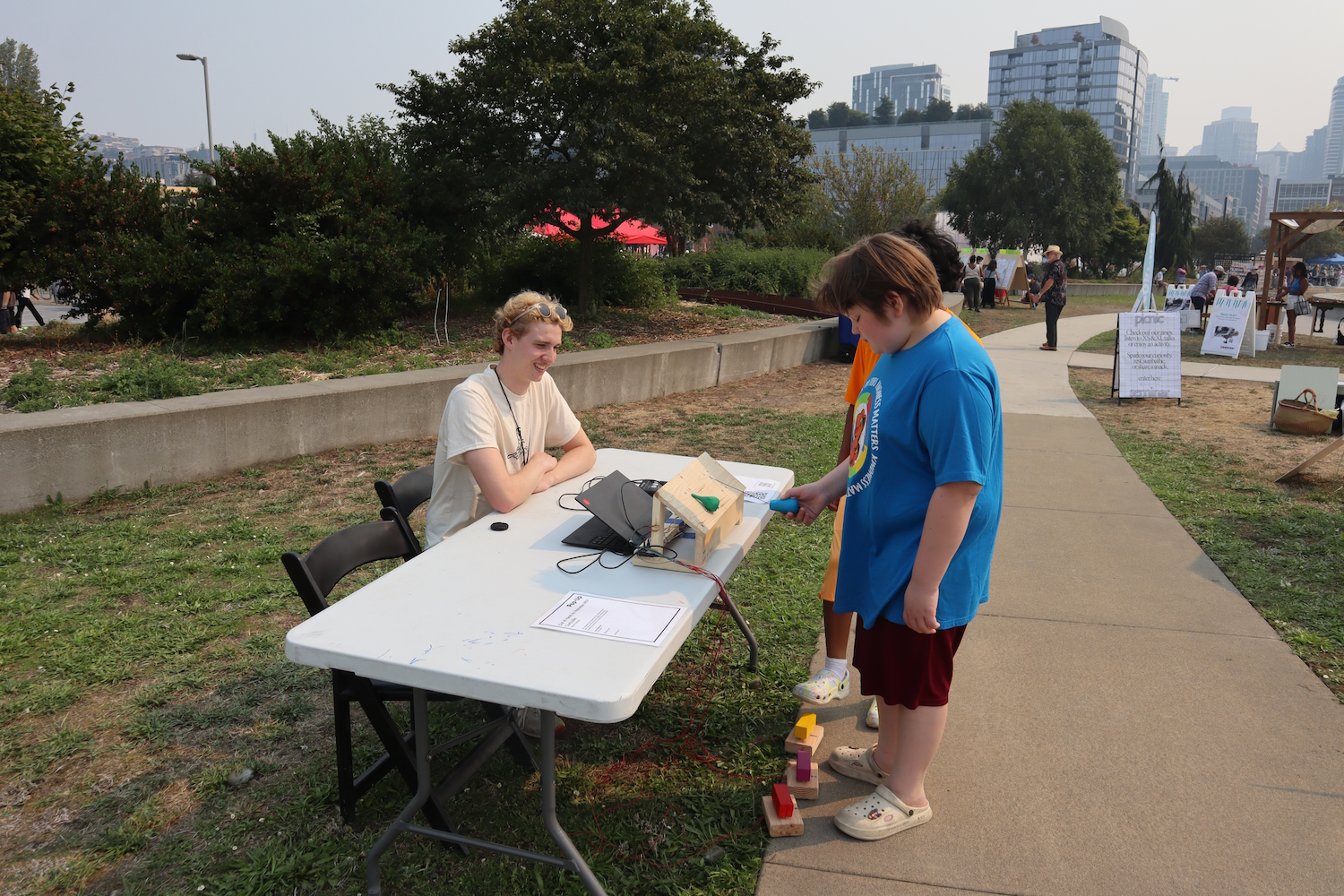 Two other Seattle Design Festival guests experiment with the controller