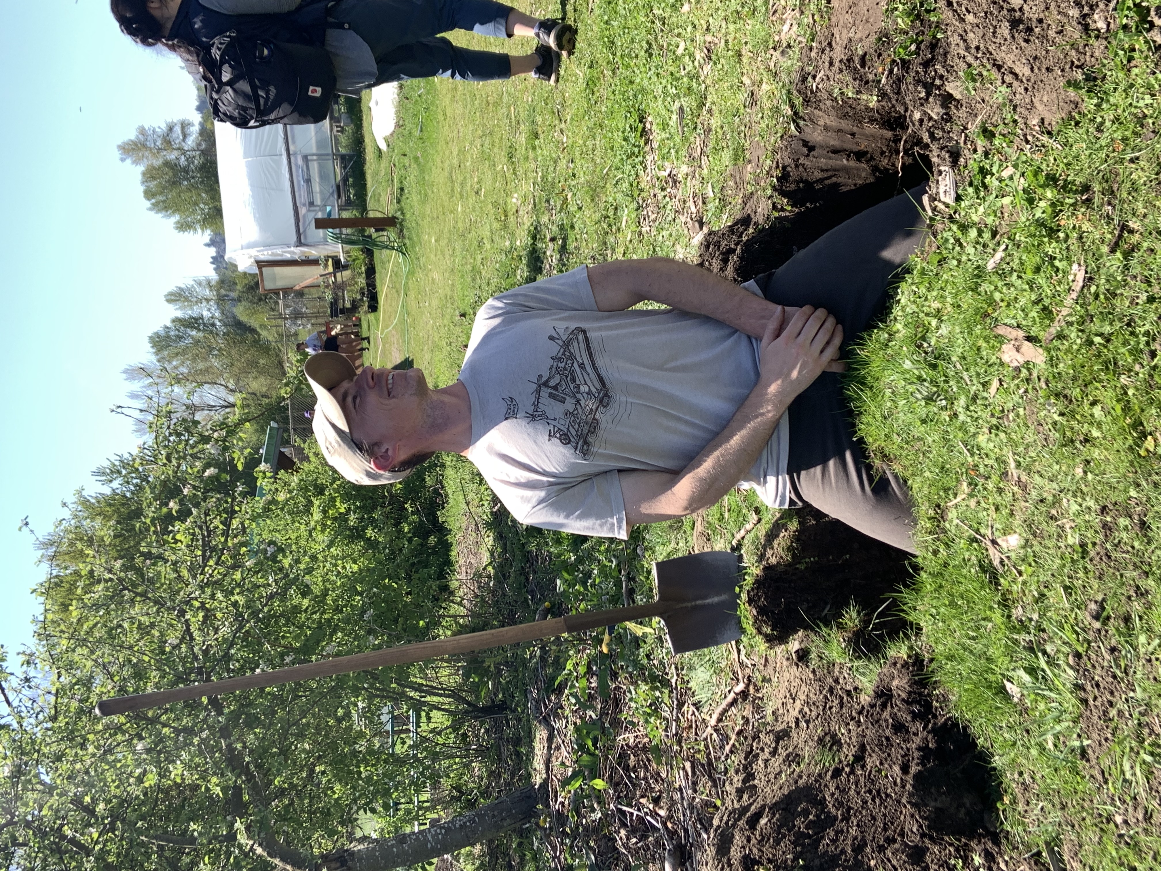 Two farm workers load steel signposts into a truck